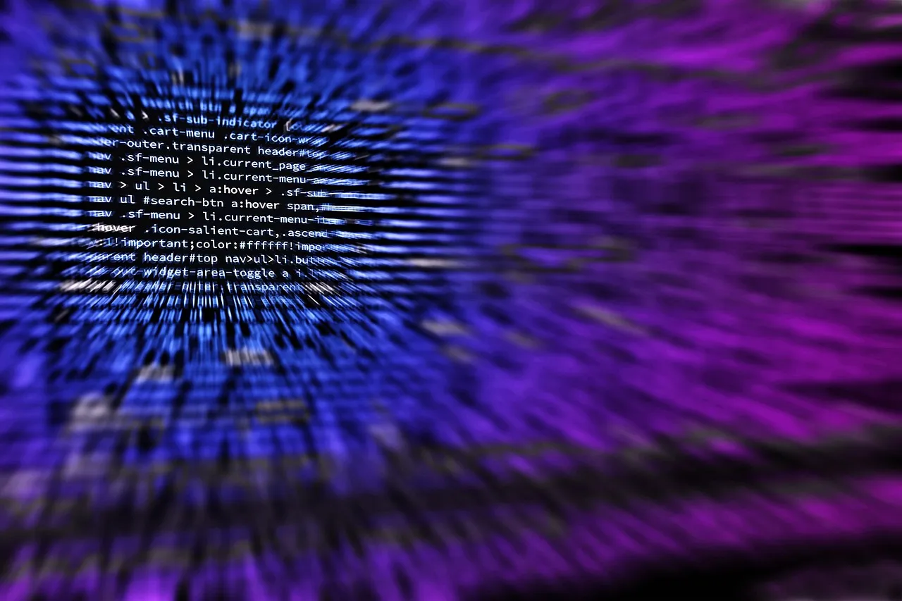 A developer working on code on a computer screen.